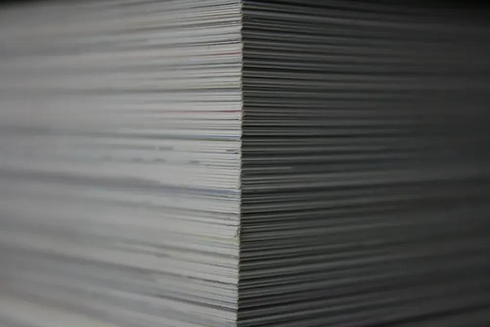 The edge of a tall stack of paper sheets, close up
