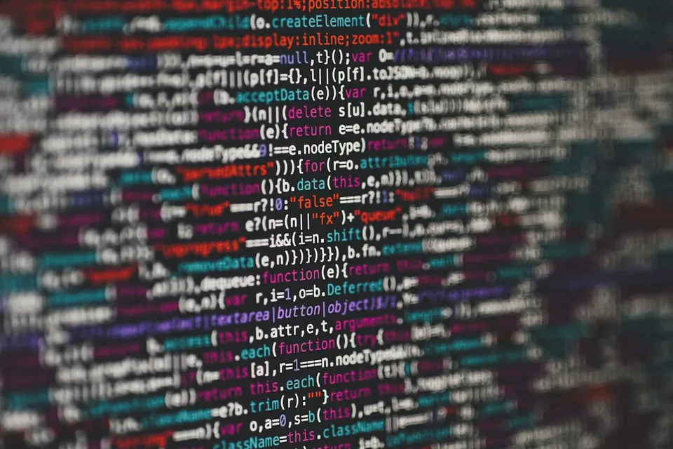 Lines of colourful source code on a dark screen, slightly out of focus