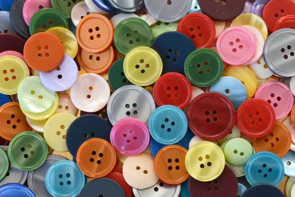 A heap of colourful plastic sewing buttons seen from above