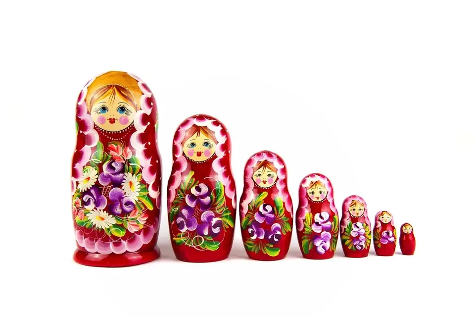 A row of painted Russian nesting dolls from largest to smallest