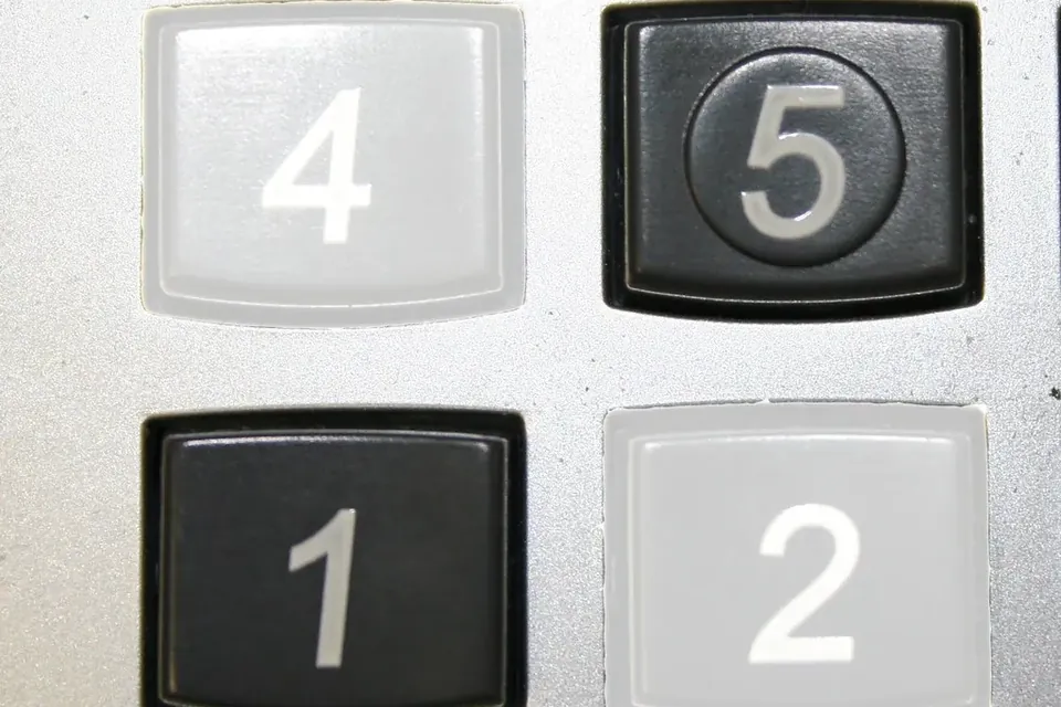 Four large number keys, 4, 5, 1 and 2, on an old adding machine