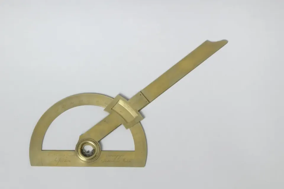 An early nineteenth-century brass protractor with a pivoting arm
